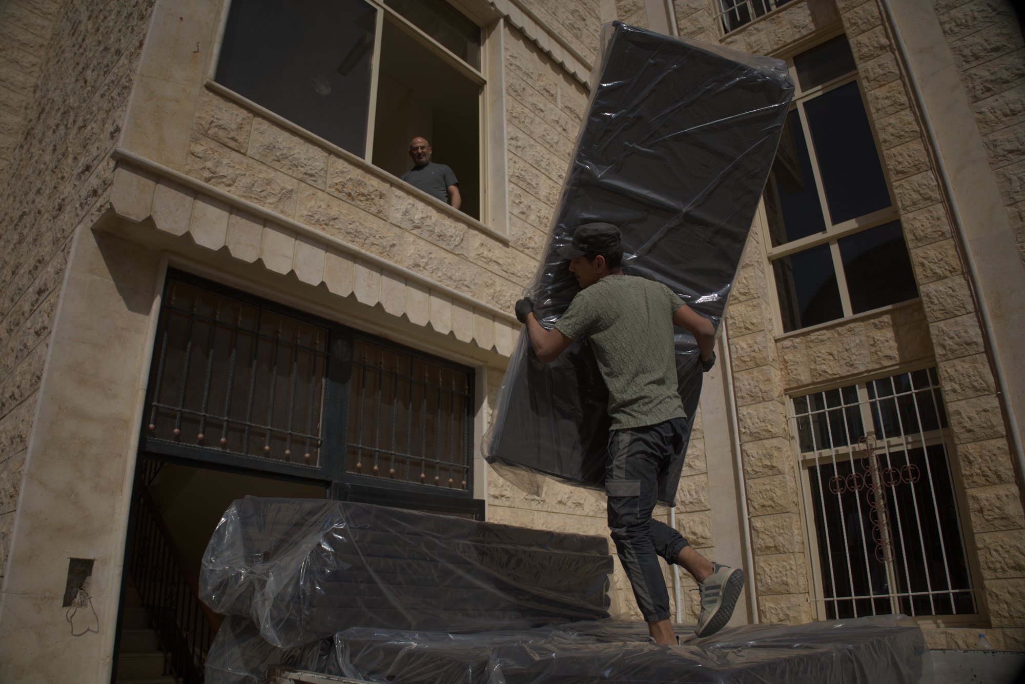 people delivering mattresses