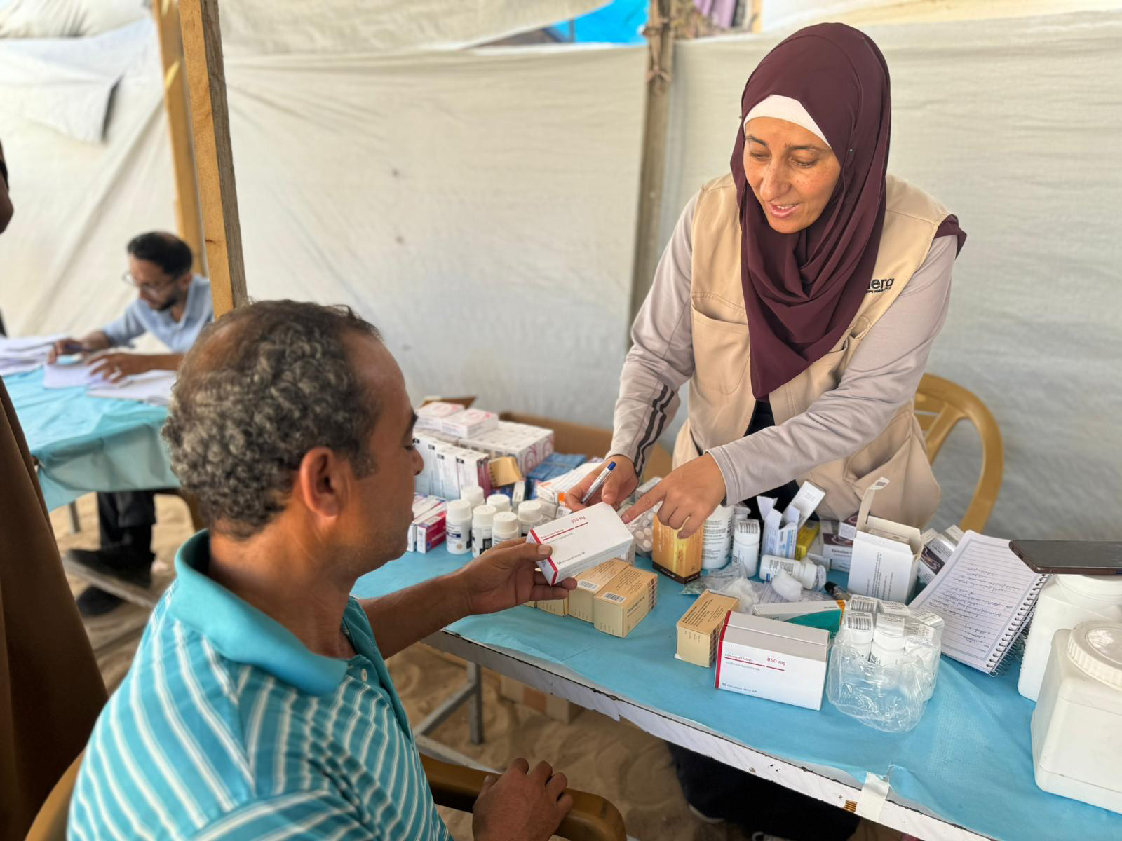A man receiving medicine from NGO workers
