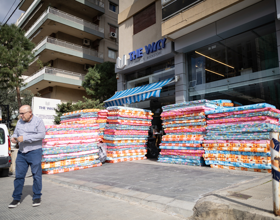 Preparation and distribution of blankets, mattresses, sanitary products and diapers to displaced families sheltering in a public school.