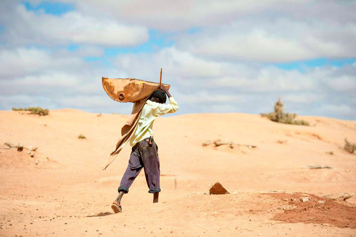 A man from Somaliland walking with water during a drought