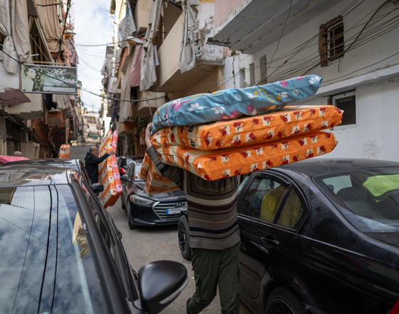 Preparation and distribution of blankets, mattresses, sanitary products and diapers to displaced families sheltering in a public school.